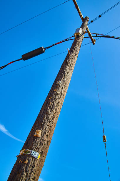 istock Looking up at power line telephone pole with vibrant blue sky 1490397459