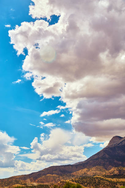 istock Looming clouds over desert mountains against blue sky 1490397542