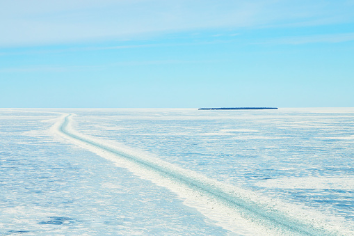 Image of Mackinaw frozen lake with path carved in ice by ship