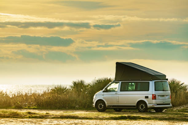istock Van with roof top tent camping on nature 1490398404