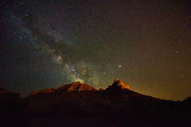 istock Milky way at night in desert with red mountains 1490399700