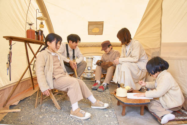 A family happily relaxing in a tent