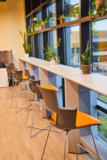 istock Modern coworking office space with desks by windows 1490399797
