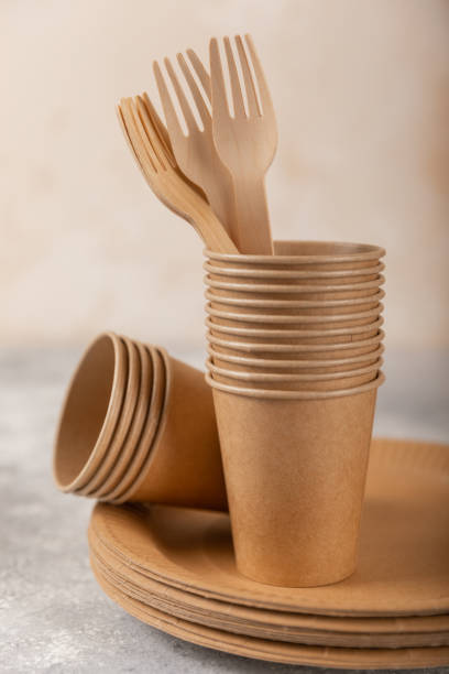 istock Eco-friendly disposable paper tableware. Paper cup, wooden forks, paper plate, cardboard box on a light background. Recycling or green concept. copy space. 1490400026