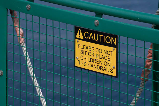 istock Warning sign on the handrail of a ship cautions passengers. 1490400667
