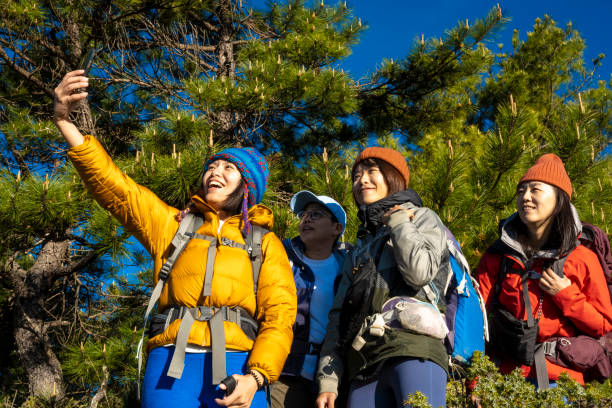 istock Friends with backpack taking selfie portrait on a mountain. 1490401973