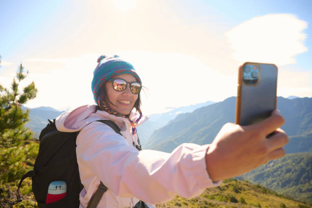 istock Friends with backpack taking selfie portrait on a mountain. 1490401985