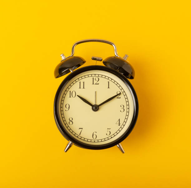 istock alarm clock on a bright yellow background.Top view.Close-up.Copy space. 1490402253