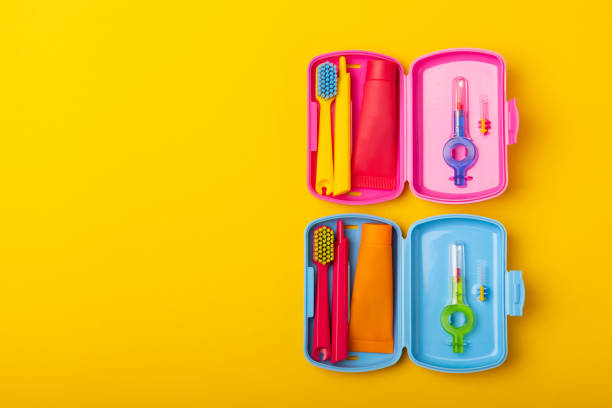 istock Oral care.Travel set with a toothbrush, toothbrush and toothpaste in a case.Composition on a textural yellow background. Dentist concept. Flat lay. copy space.Place for text 1490402383