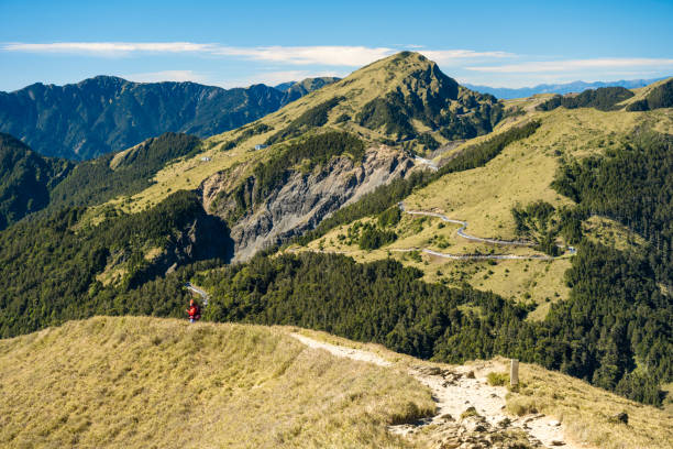 Hikers walking alone on top of a mountain.