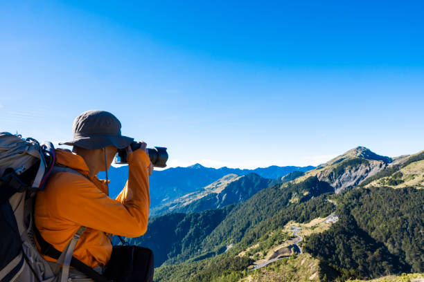 istock Mountain hiker taking photos on the mountain top. 1490403531