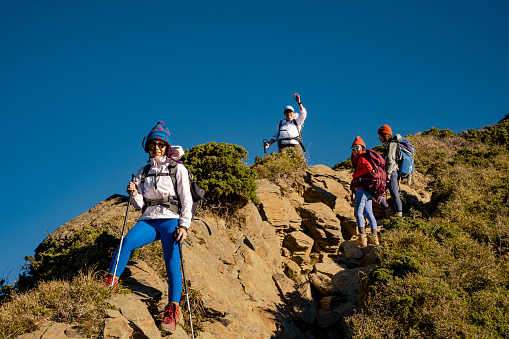 Good friends hiking together on the mountain.