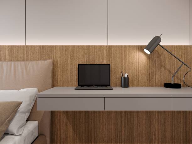 istock laptop on grey desk and reading lamp, 3d render 1490405110