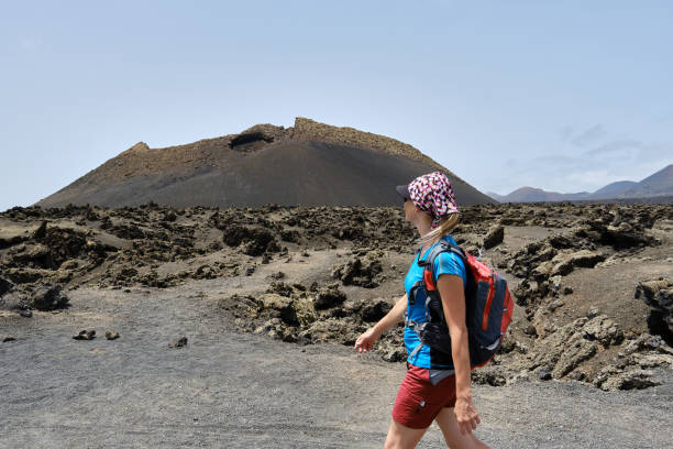 A Tourist woman visiting El Cuervo volcano, lanzarote, spain stock photo
