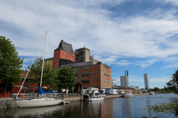 istock View of industry buildings by river against cloudy sky 1490409368