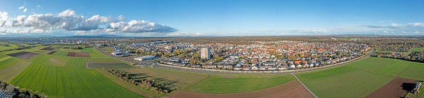 Drone panorama of German settlement Koenigstaedten near Ruesselsheim with Frankfurt skyline in the background during daytime