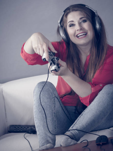 istock Young woman playing video games 1490409963