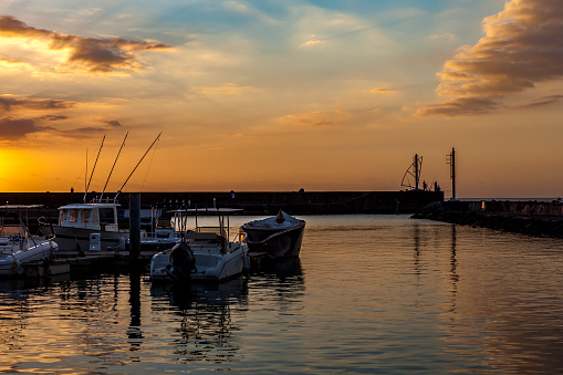 sunset at the harbor wall, small village, la reunion island.