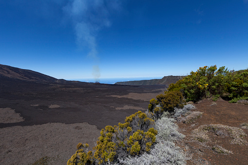 lava erruption smoke at the horizon of piton de la fournais volcano, la reunion island, mascarene islands, indian ocean islands, french overseas territory, france.