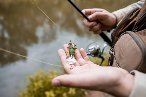 the fisherman shows off his frog-shaped decoy