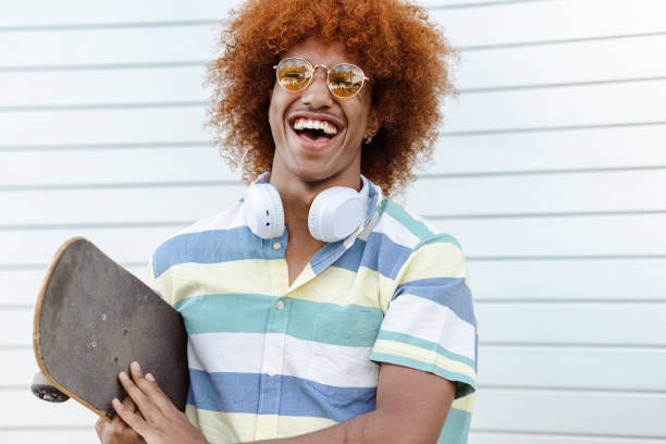 istock A smiling young man with an Afro hairstyle is standing against a white background 1490412170