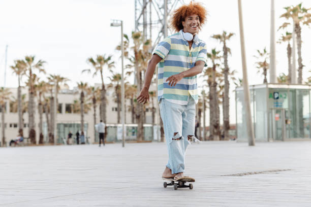 istock A cheerful Black man is skateboarding along the street 1490412193