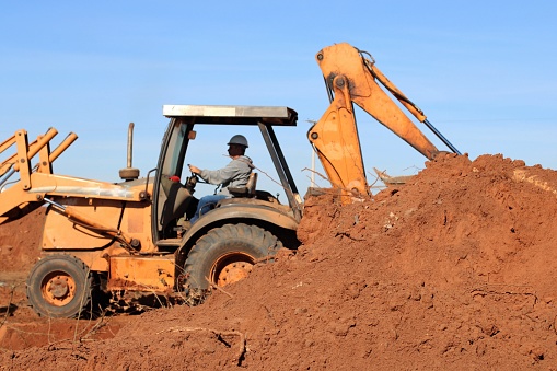 man operating a backhoe machine