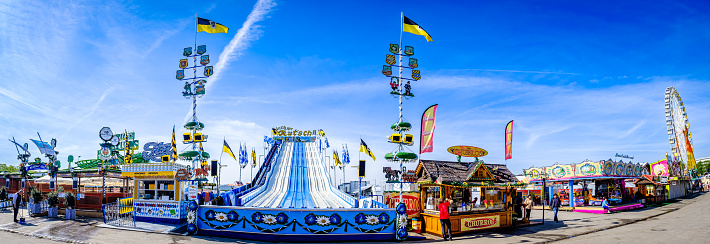Blora, Indonesia - Dec 24, 2022: Local amusement fun fair with Ferris wheels at the night market.