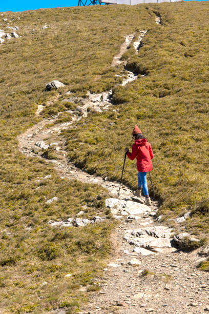 Hikers walking alone on top of a mountain.