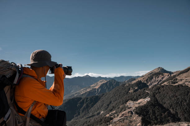 istock Mountain hiker taking photos on the mountain top. 1490415842