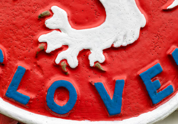 Word Love in blue beveled letters in on red Close-up of a vintage 1930s state symbol of Czechoslovakia with part of the word "CeskosLOVEnska" and white heraldic lion paw former czechoslovakia stock pictures, royalty-free photos & images