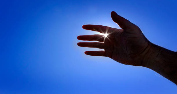 istock Hand Reaching Towards Heaven Seeking Help Sunstar Sunshine Inspiration Help from Above 1490420353
