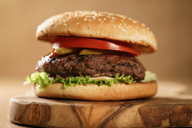 istock fresh homemade burger with marble beef, cheese and vegetables on olive board 1490420465