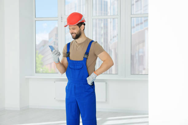 istock Professional repairman in uniform with phone indoors 1490424538