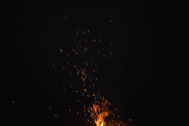 sparks from bonfire in the night with dark background, outdoor