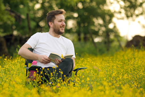 Young Man Reading in Nature, Springtime , Positive Emotion, Quality Leisure Activity