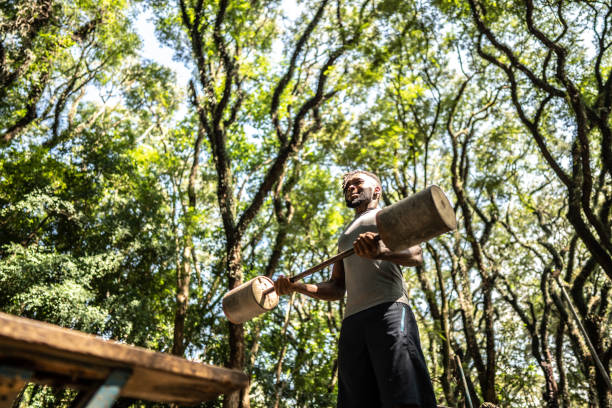 Young man doing weightlifting in the park