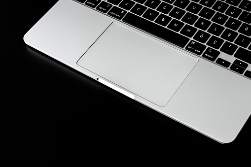 Keyboard and trackpad, grey keyboard on black background