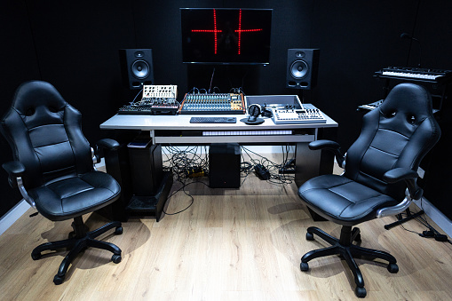 Recording equipment in studio. Studio microphone with headphones and mixer background. Elevated view