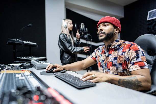 Producer man using a sound mixer in the recording studio