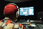 Rear view of a producer man in the recording studio