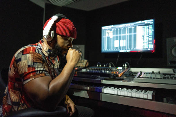 istock Producer man reflecting  while listen a sound in the recording studio 1490436618