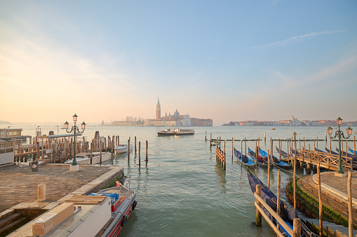 This photograph captures the enchanting and mysterious beauty of Venice, with the peaceful waters of the lagoon and the colorful sunrise sky creating a magical atmosphere.