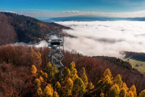 Aerial Drone Shot: Sightseeing Tower in Brezno, Autumn Scenery with Misty Morning and Cloud Inversion in Horehronie Region