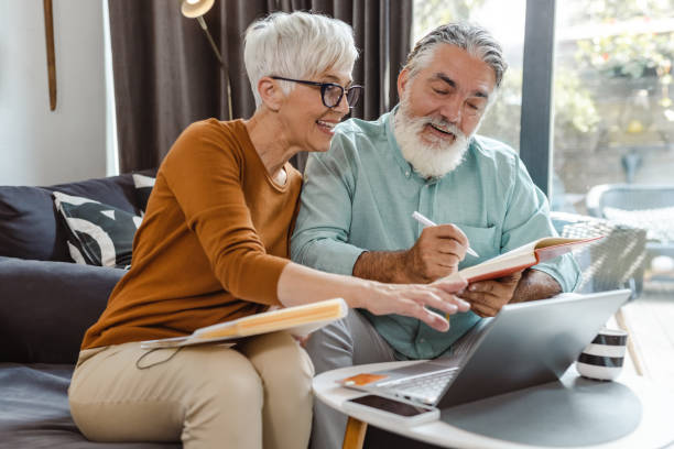 istock Senior couple discussing home finances and using laptop 1490441003