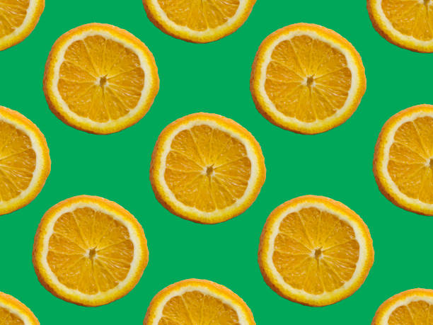 istock Seamless pattern with orange slices on a green background. 1490441902