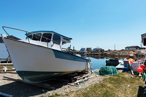 Boat on stand on the shore, close up on the part of the yacht, luxury ship, maintenance and parking place boat, marine industrial