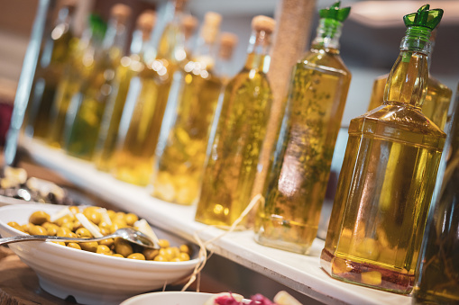 Breakfast olives and jars of pickles on plates at a buffet