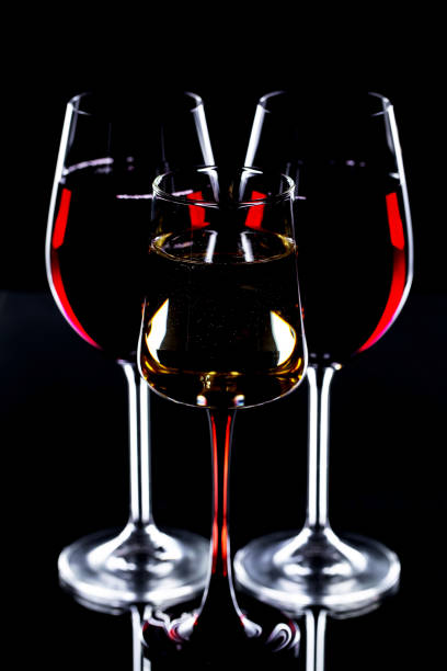 istock Red wine in a glass, on a black background. 1490448215