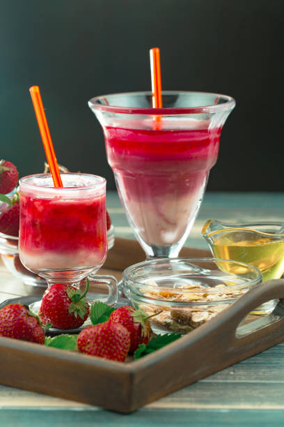 istock Strawberry yogurt in a glass on the table. 1490448471